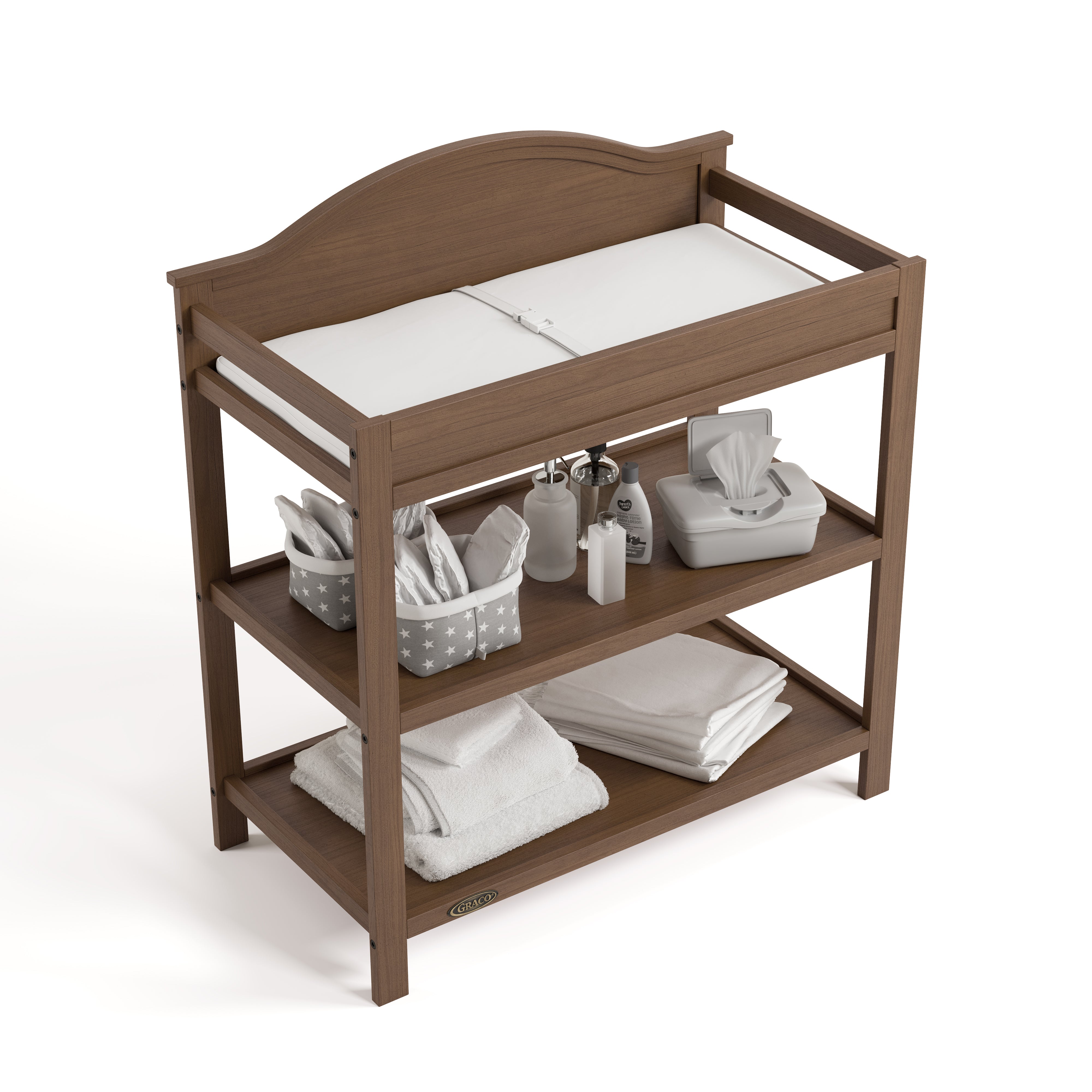 story hazelnut changing table with changing pad and changing essentials top view