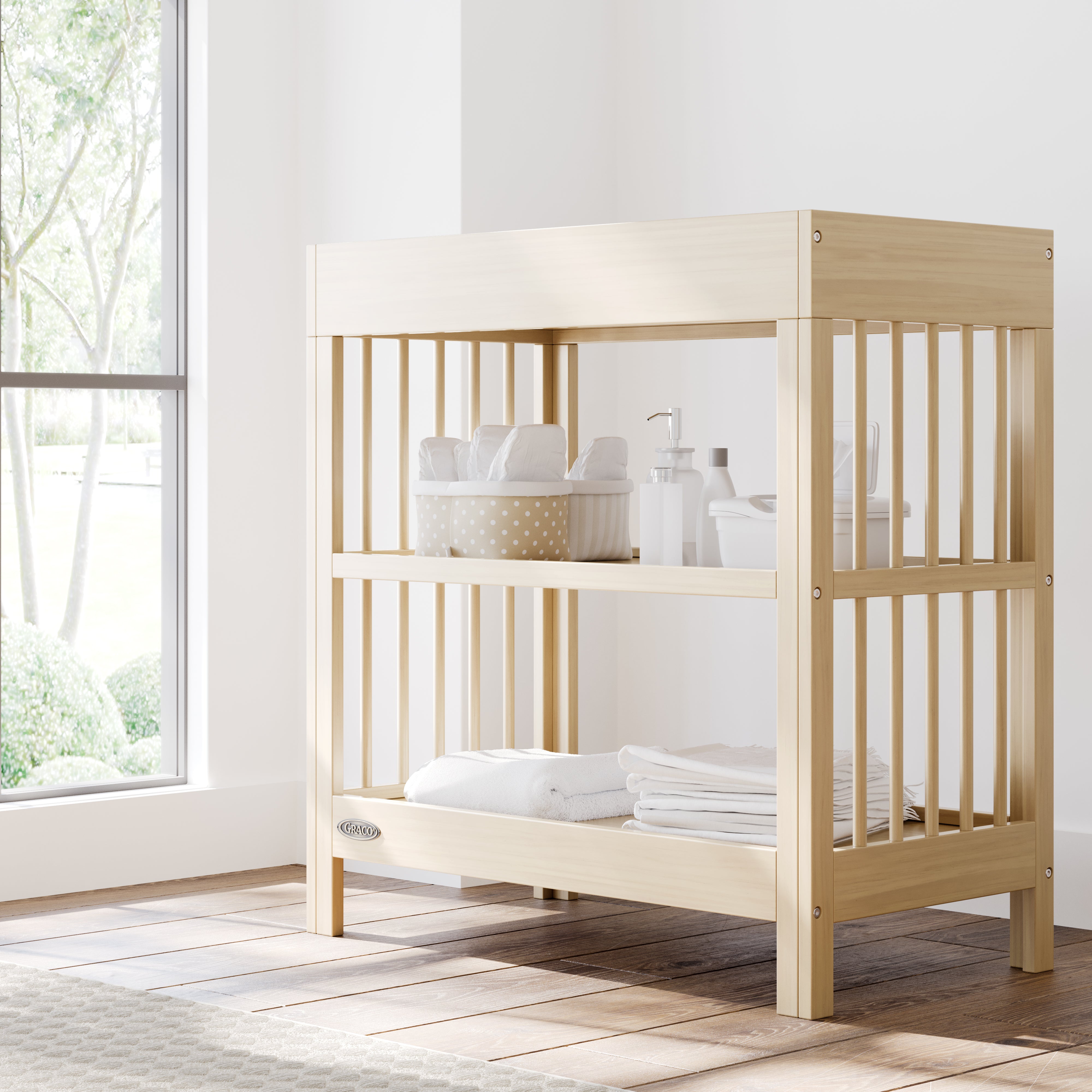 teddi driftwood changing table in nursery with changing essentials on both shelves