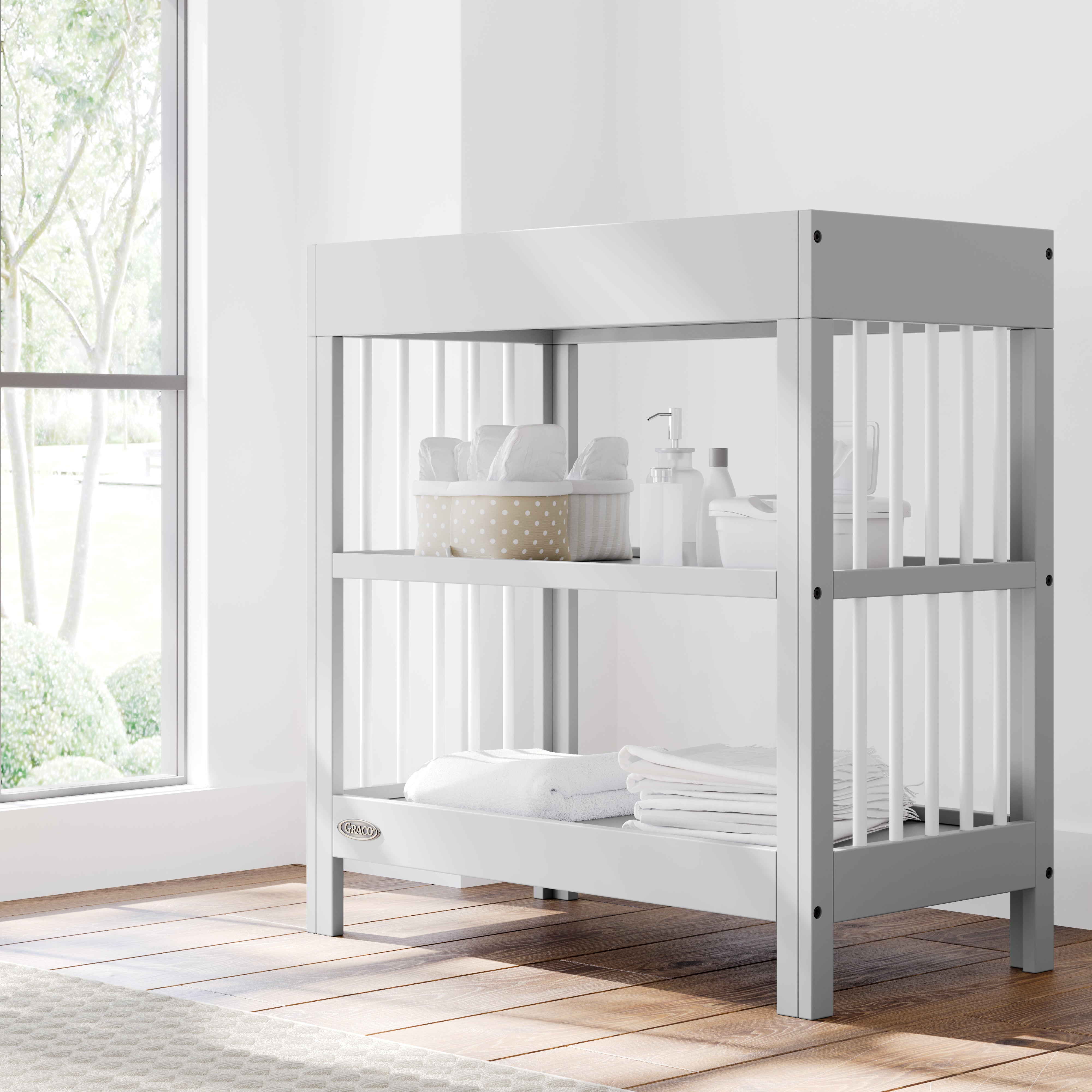 teddi pebble gray with white changing table in nursery with changing essentials on both shelves