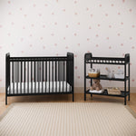 pasadena changing table black with crib front view in bedroom