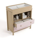 alpine 2 drawer changing chest blush with driftwood top view with changing pad and changing essentials in exterior shelves and top drawer