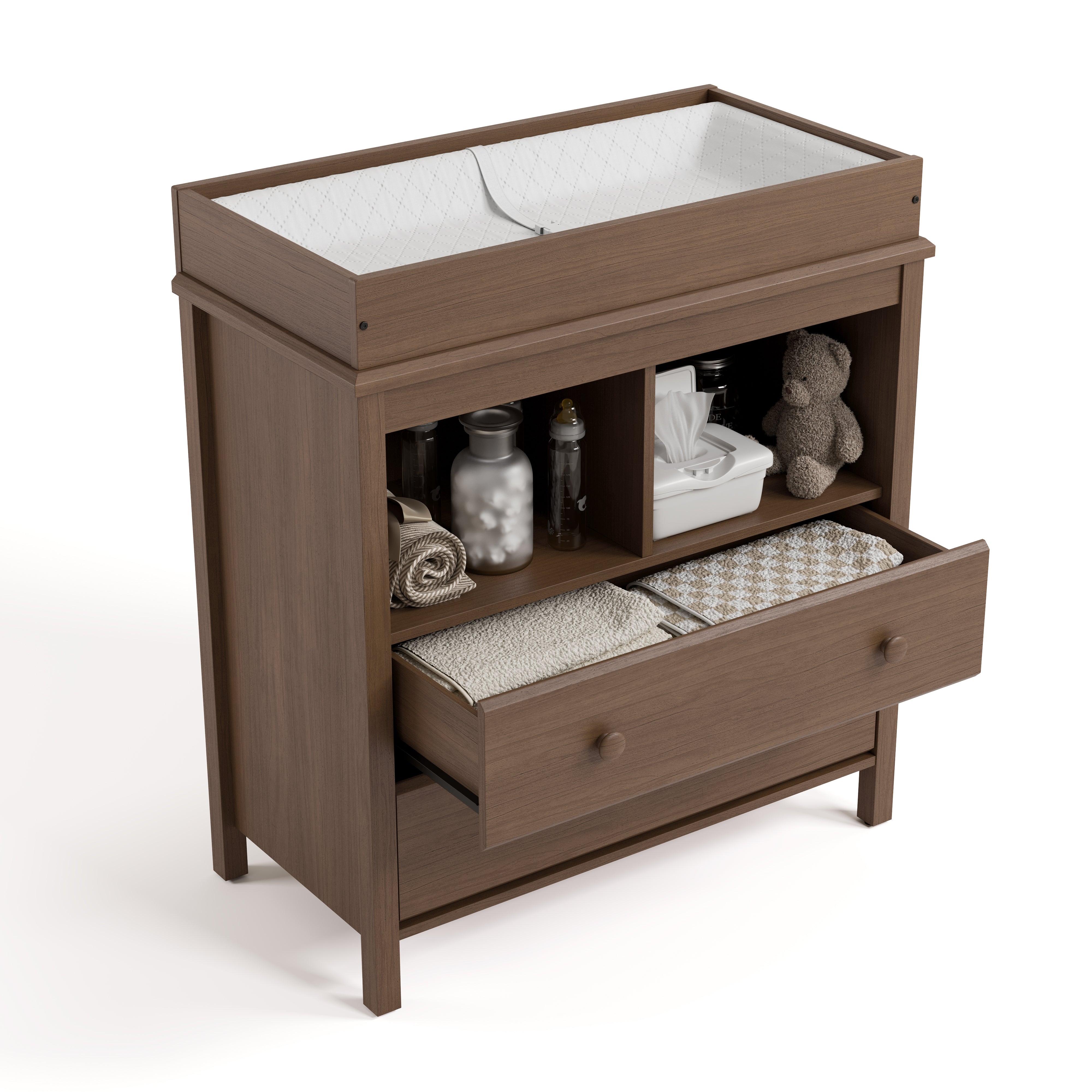 alpine 2 drawer changing chest hazelnut top view with changing pad and changing essentials in exterior shelves and top drawer