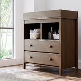 alpine 2 drawer changing chest hazelnut nursery room shot with changing essentials in exterior shelves