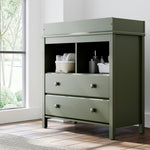 alpine 2 drawer changing chest olive nursery room shot with changing essentials in exterior shelves