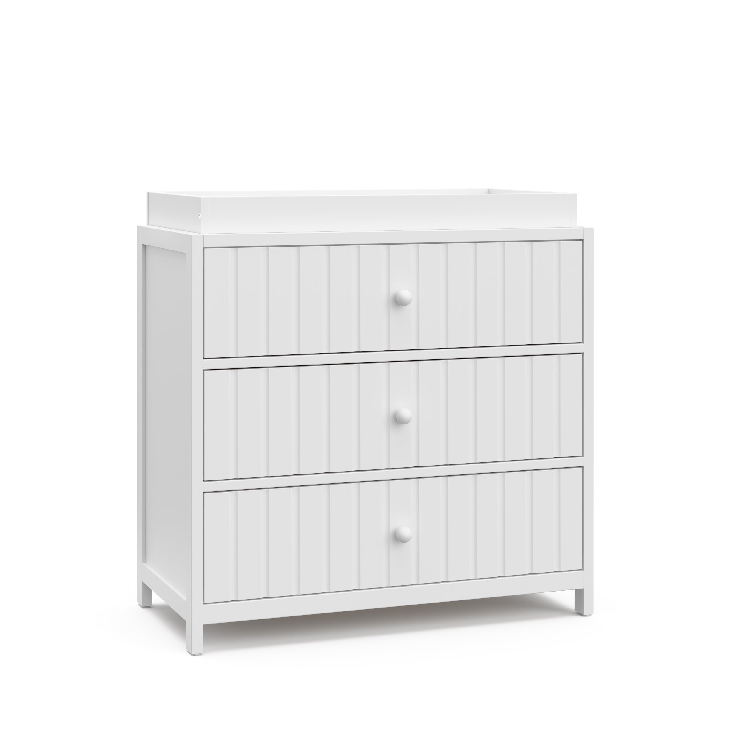 Angled view of white 3 drawer chest with changing topper