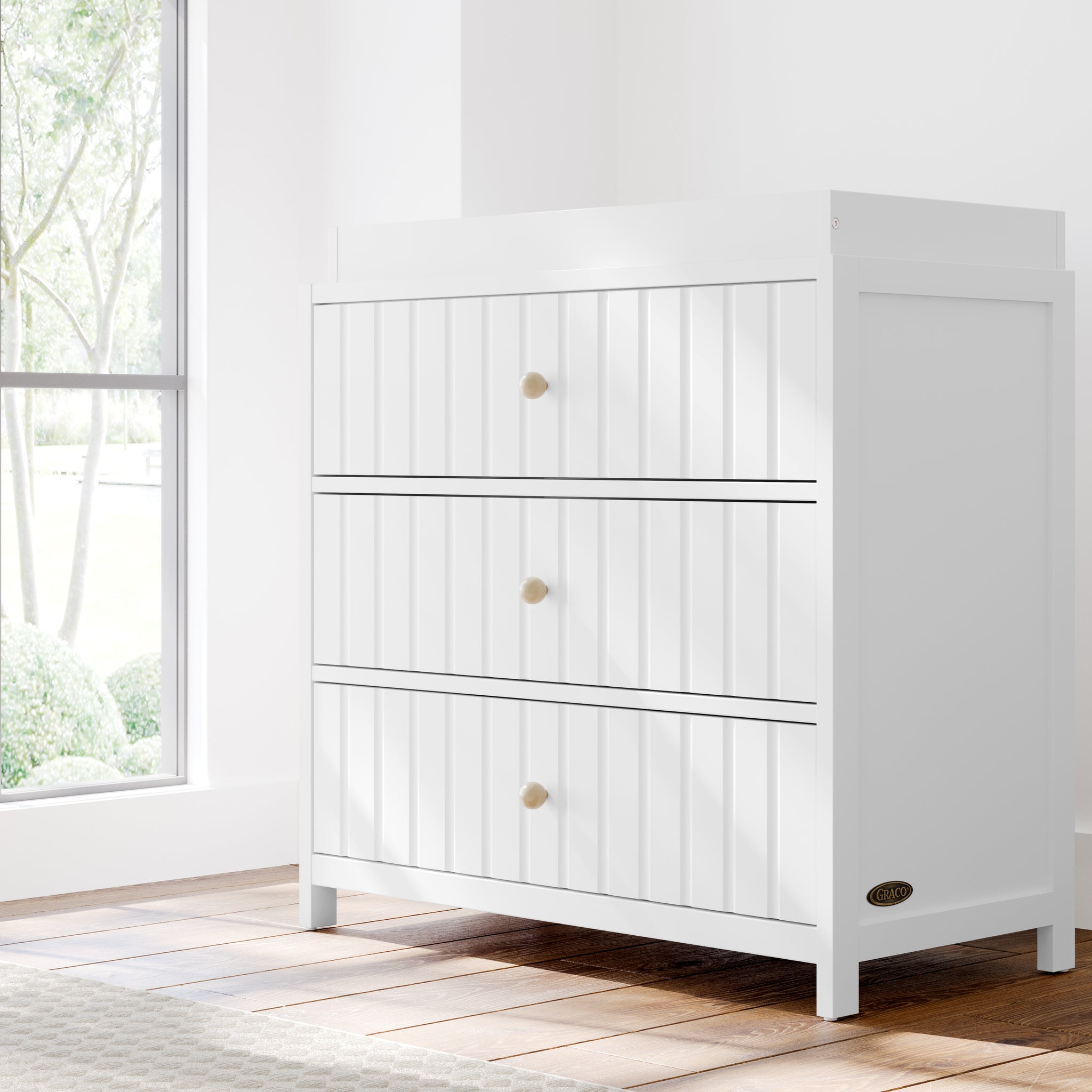 White 3 drawer chest with changing topper in nursery