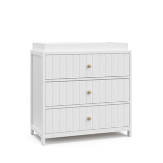 Angled view of white 3 drawer chest with changing topper