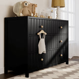 Black 6 drawer dresser in nursery setting