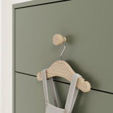 close up view of olive dresser with driftwood knobs