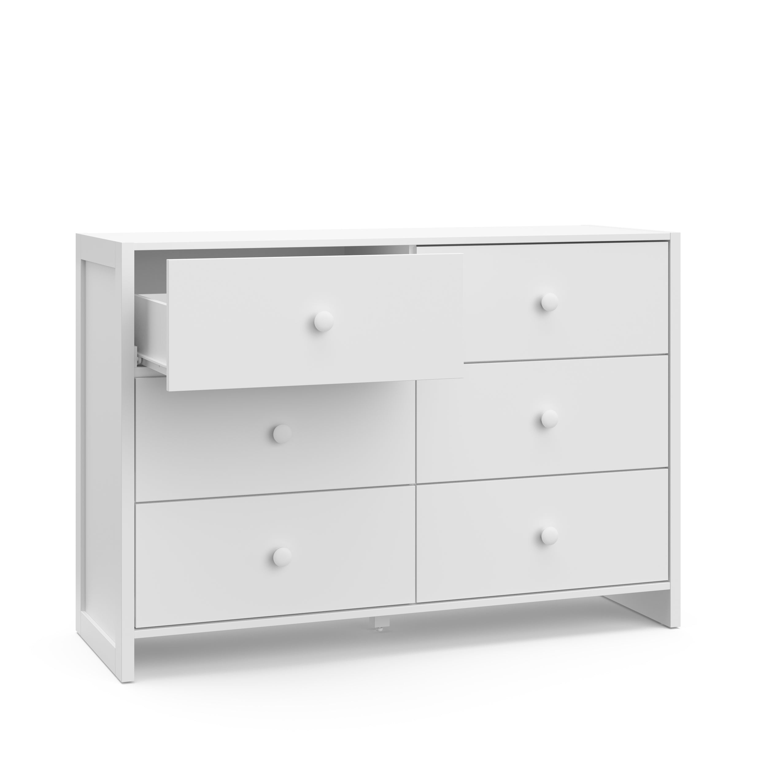 Angled view of white dresser with one open drawer