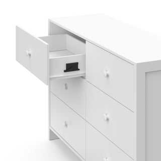  Top-side view of a white dresser with one open drawer, showcasing an interlocking drawer system.