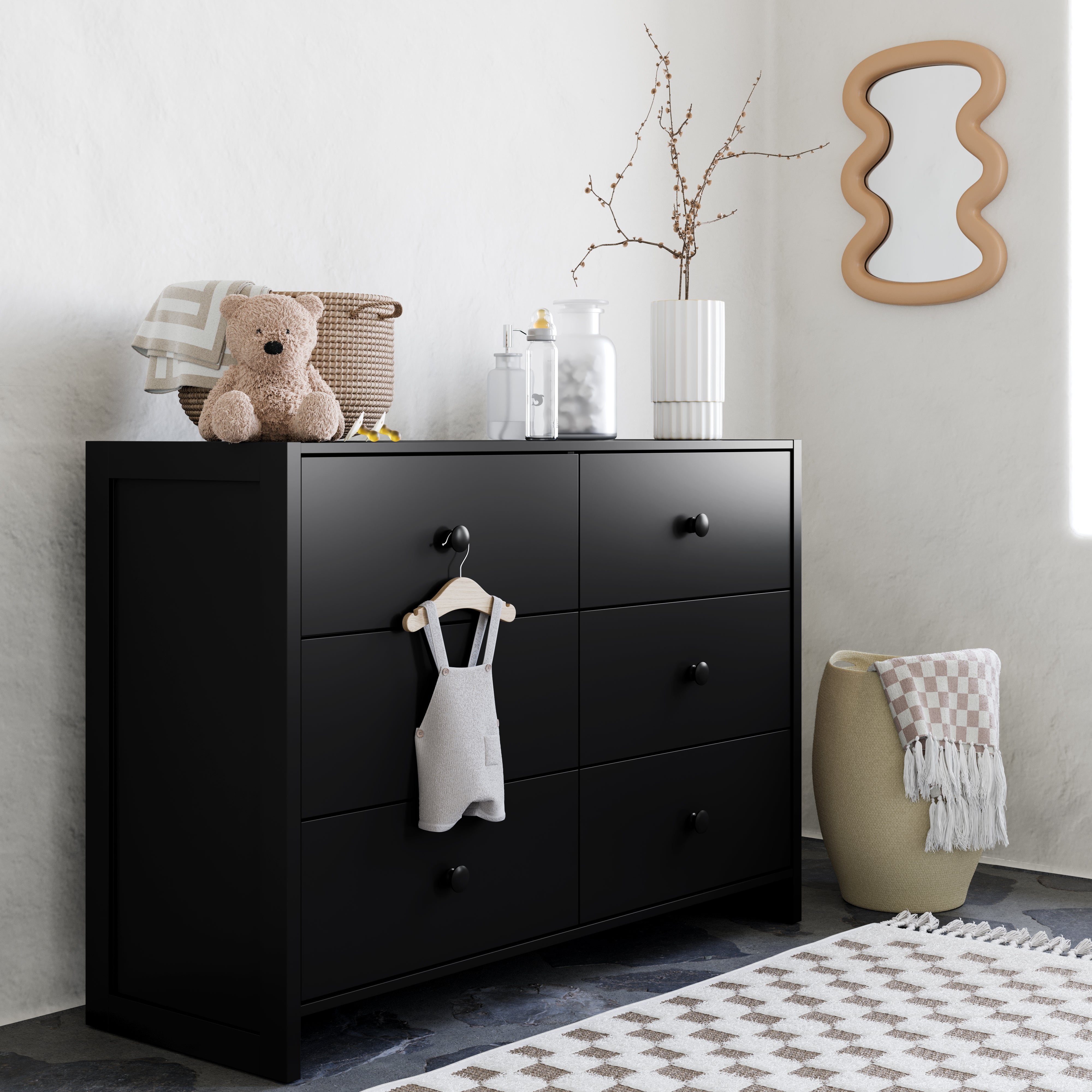 Black dresser in a nursery