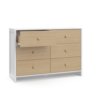 Angled view of white with driftwood dresser with one open drawer