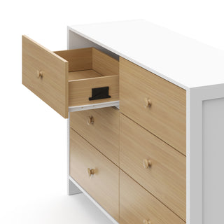 Top-angled view of a white with driftwood dresser with one open drawer, showcasing an interlocking drawer system.