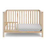 natural crib in toddler bed conversion with one toddler safety guardrail