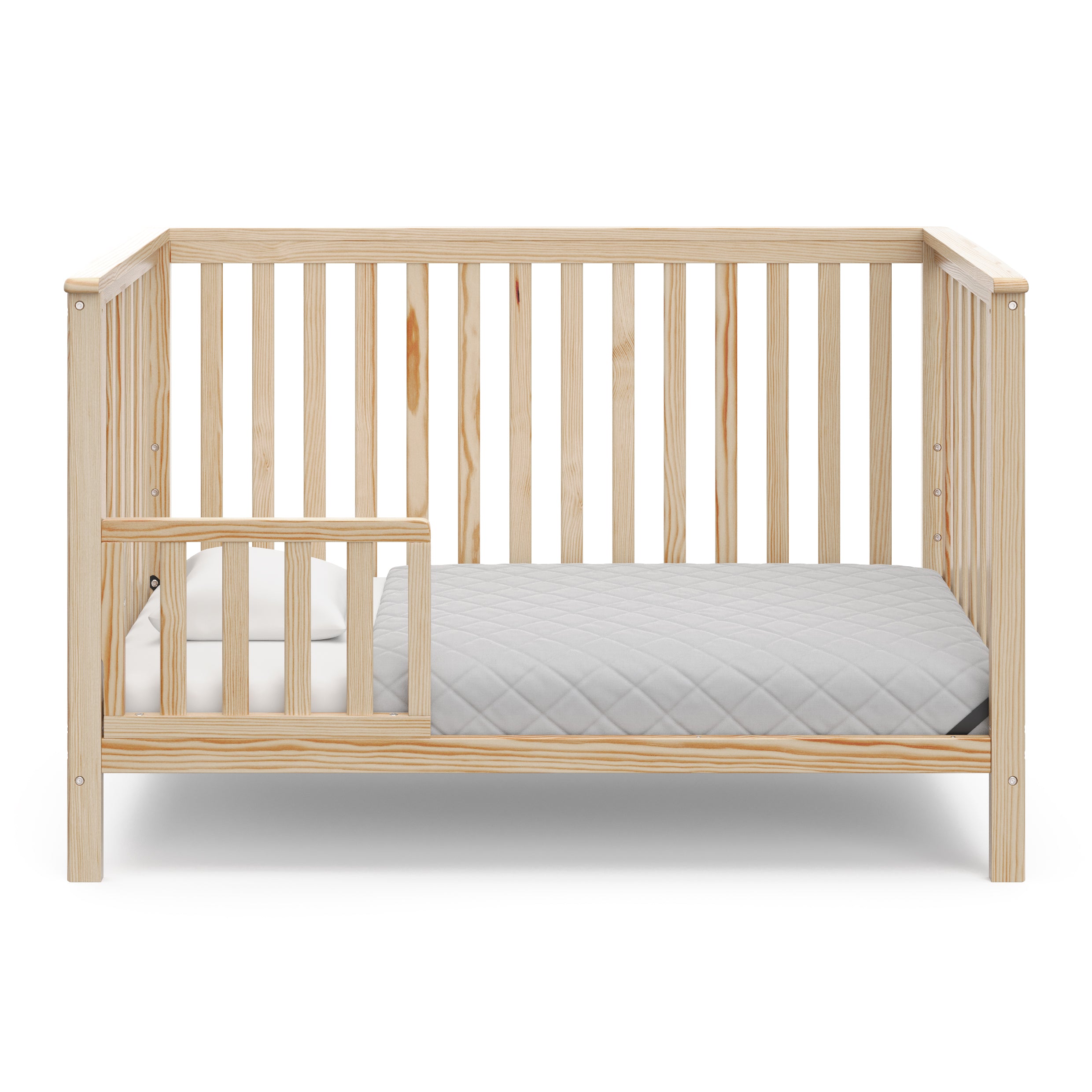 natural crib in toddler bed conversion with one toddler safety guardrail