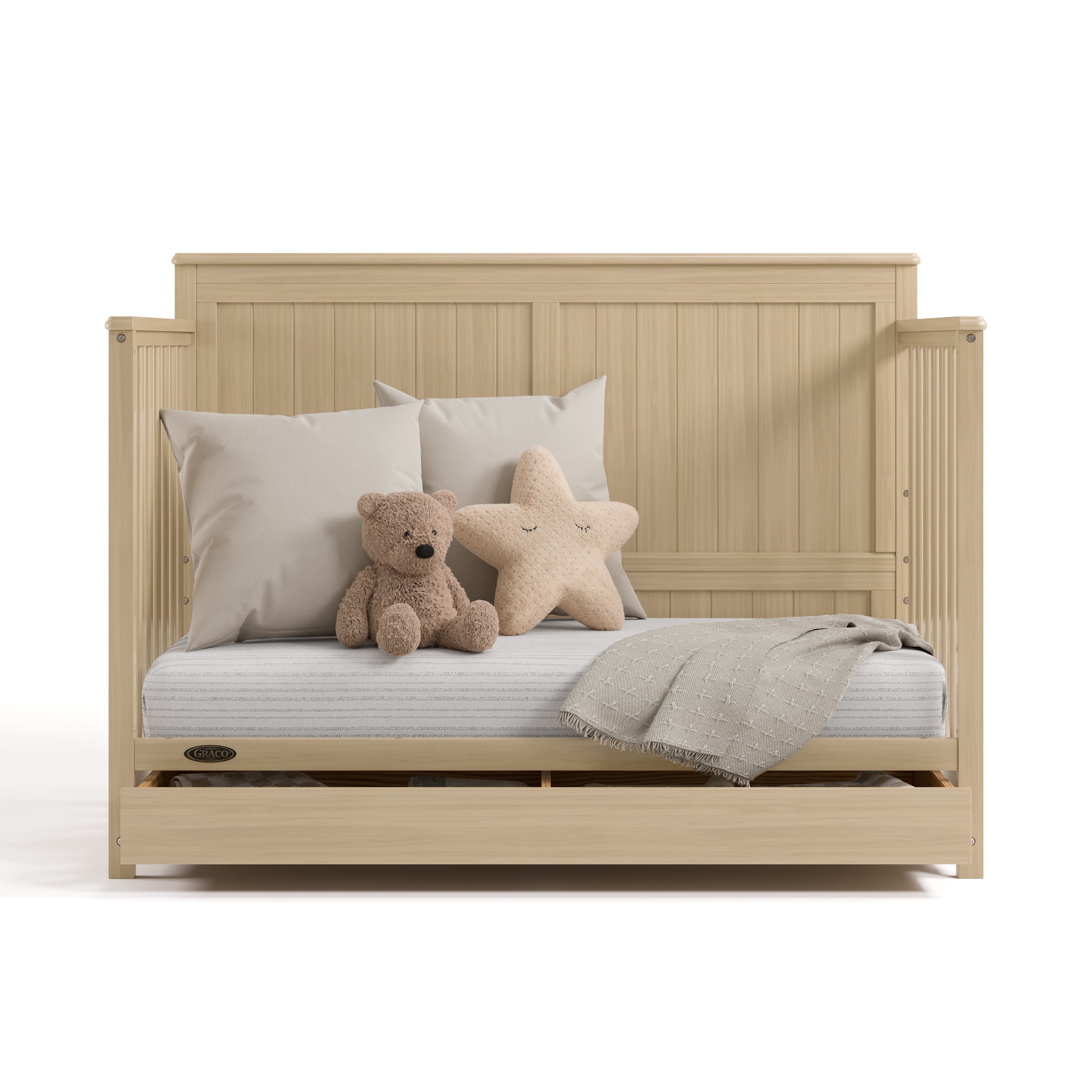 hadley driftwood crib with drawer daybed conversion with pillows blanket and teddy bear