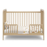 Driftwood crib in toddler bed conversion with two guardrails