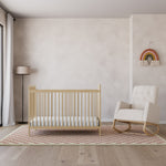 Driftwood crib with ivory and natural base rocking chair in nursery