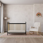 Black with Driftwood crib with ivory and natural base rocking chair in nursery