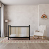 Black with Driftwood crib with ivory and natural base rocking chair in nursery