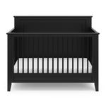 black crib with dowels and solid headboard