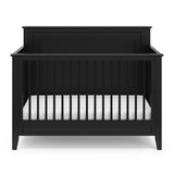 black crib with dowels and solid headboard