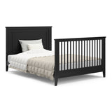 black crib in full-size bed conversion with both headboard and footboard