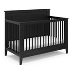 black crib with dowels and solid headboard