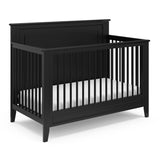 black crib with dowels and solid headboard