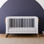 white and vintage driftwood crib in nursery