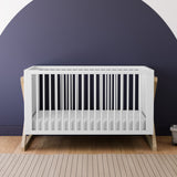 white and driftwood crib in nursery