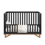 black with vintage driftwood crib in toddler bed conversion with two toddler safety guardrails