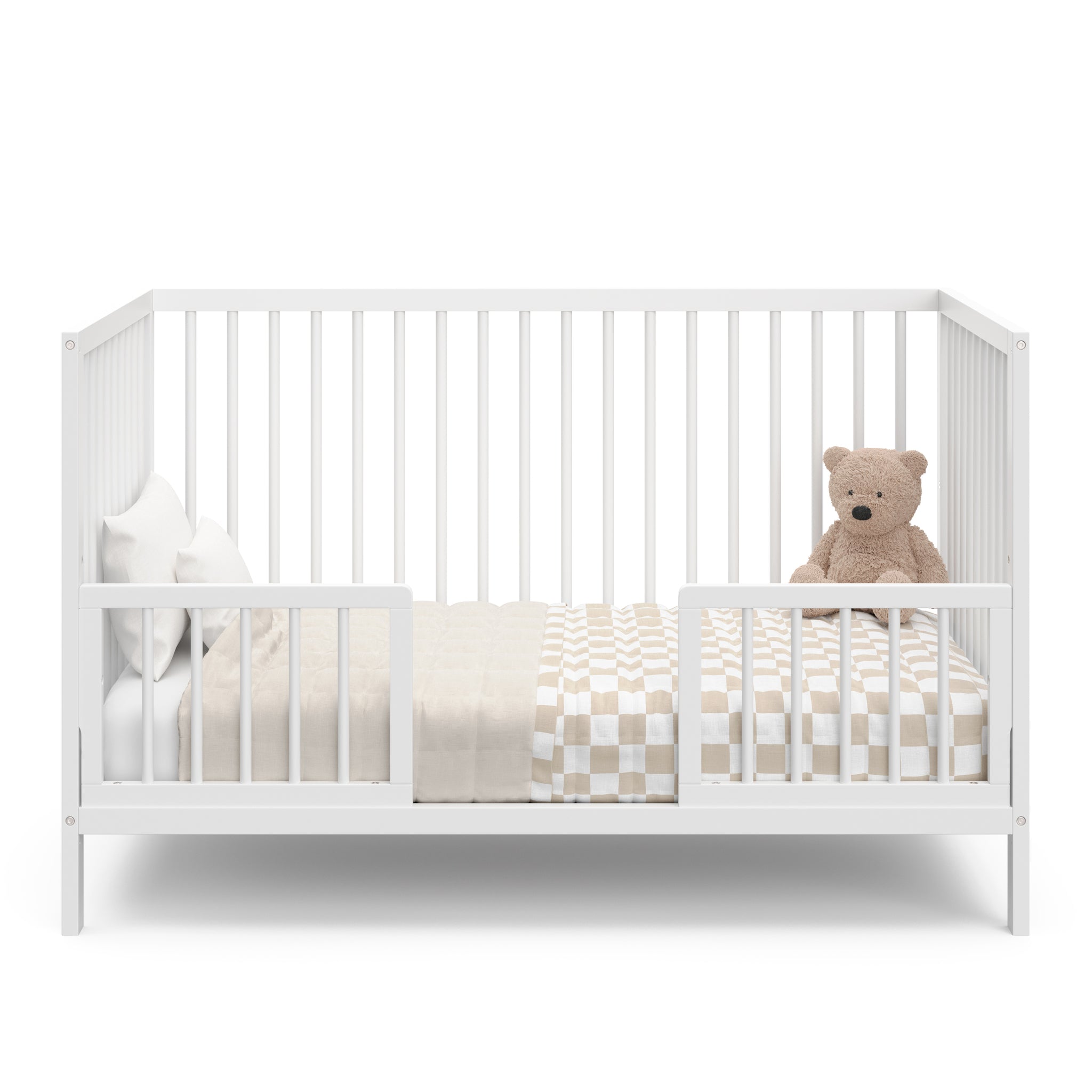white crib in toddler bed conversion with two guardrail