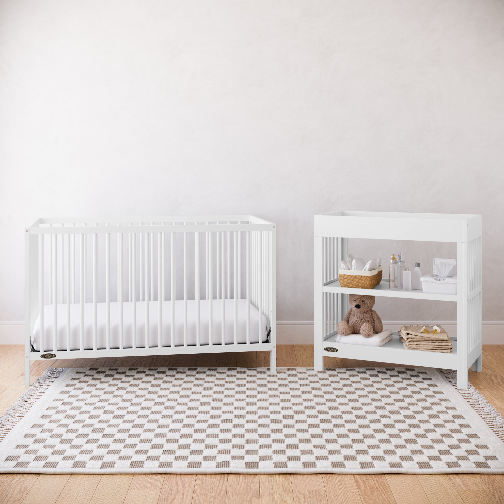 White crib and changing table in a nursery