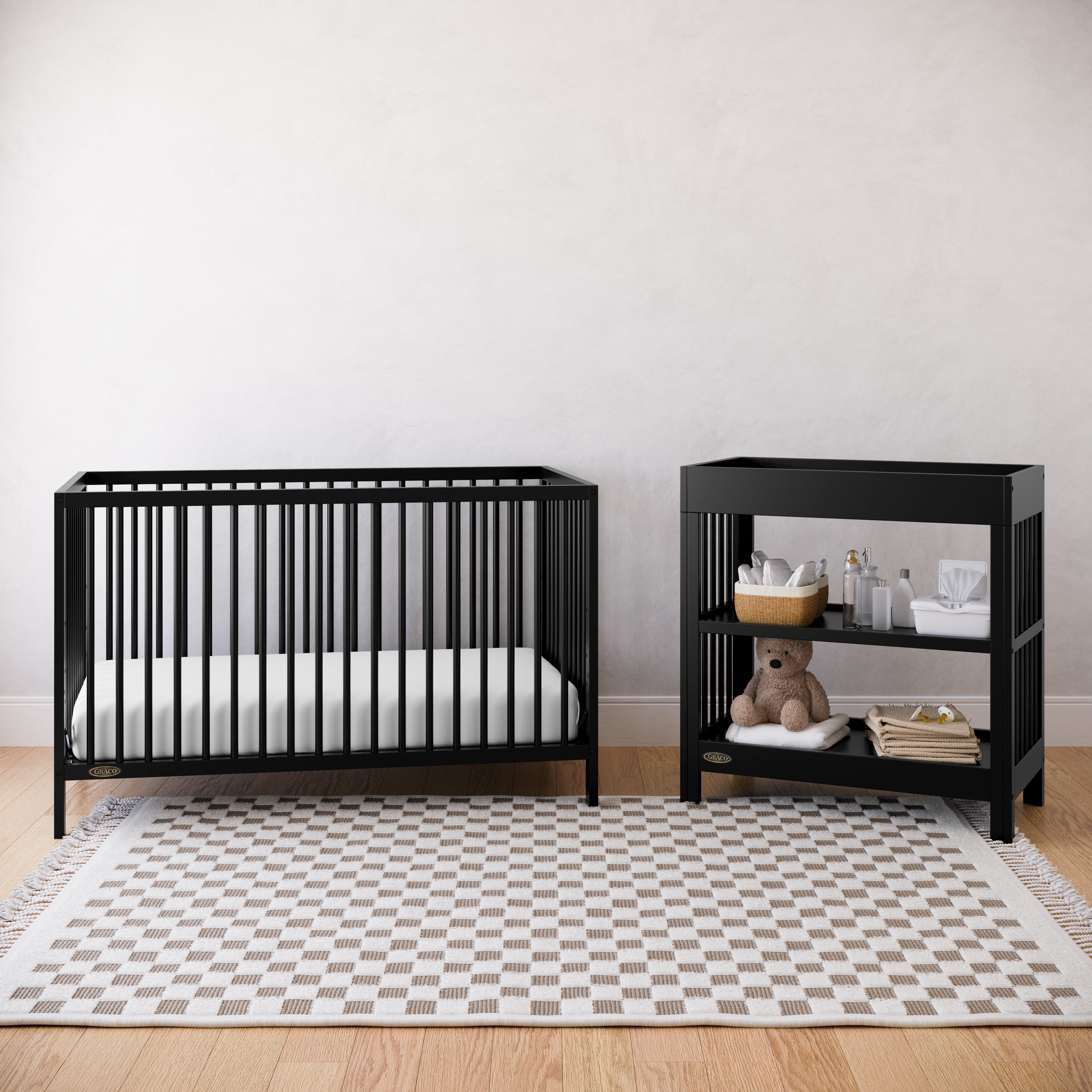 Black crib and changing table in a nursery