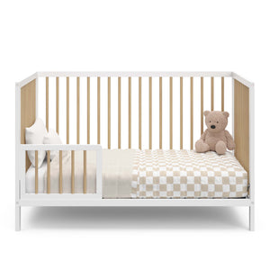 white with driftwood crib in toddler bed conversion with one guardrail