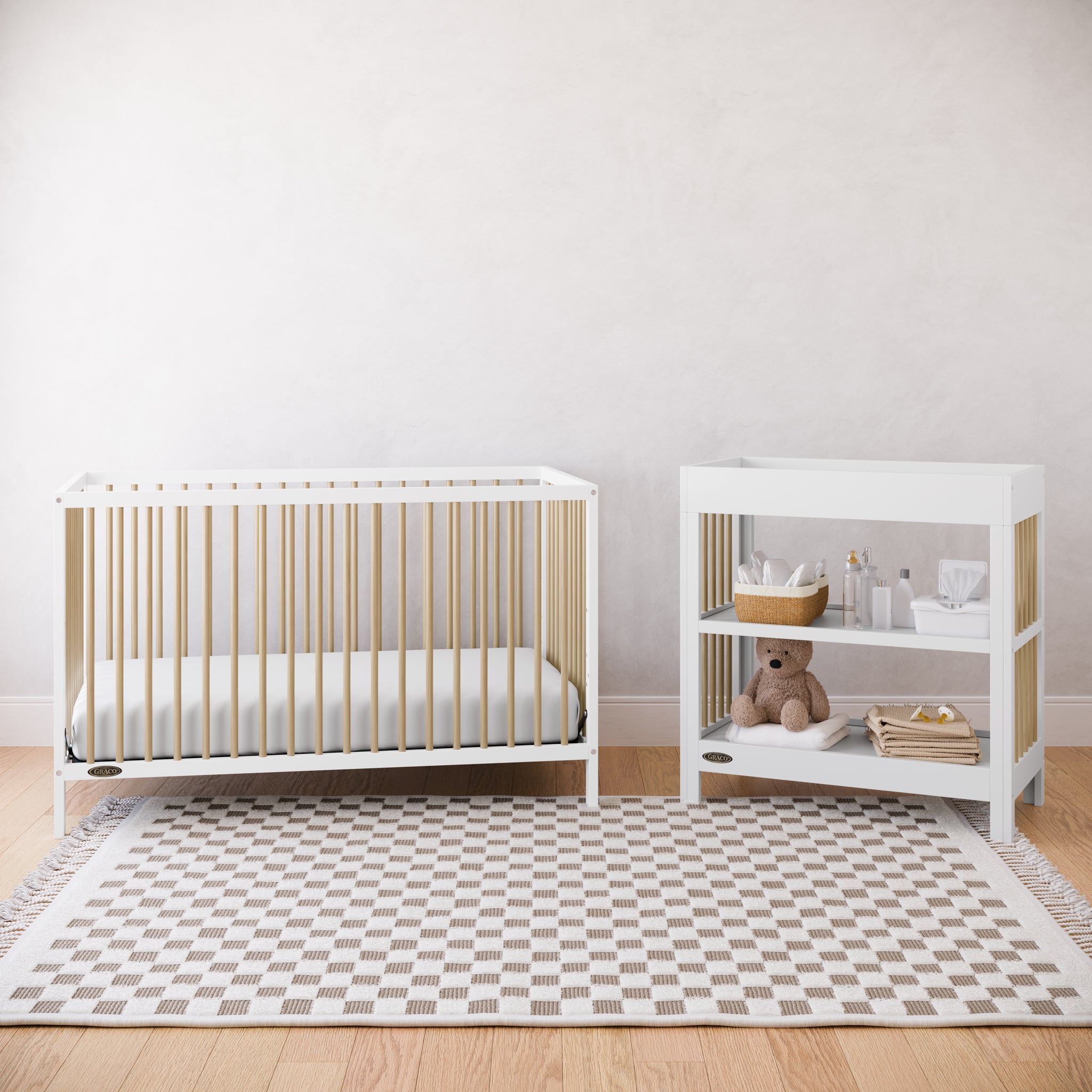 White crib and changing table with driftwood accents in a nursery