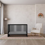 black crib with a rocker in ivory, in nursery calabasas