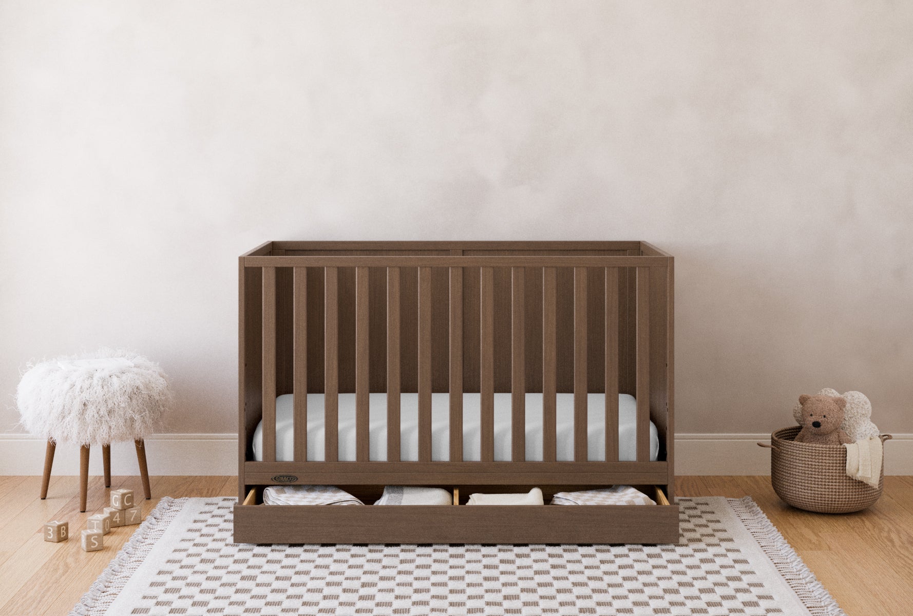 theo crib hazelnut with drawer open nursery shot