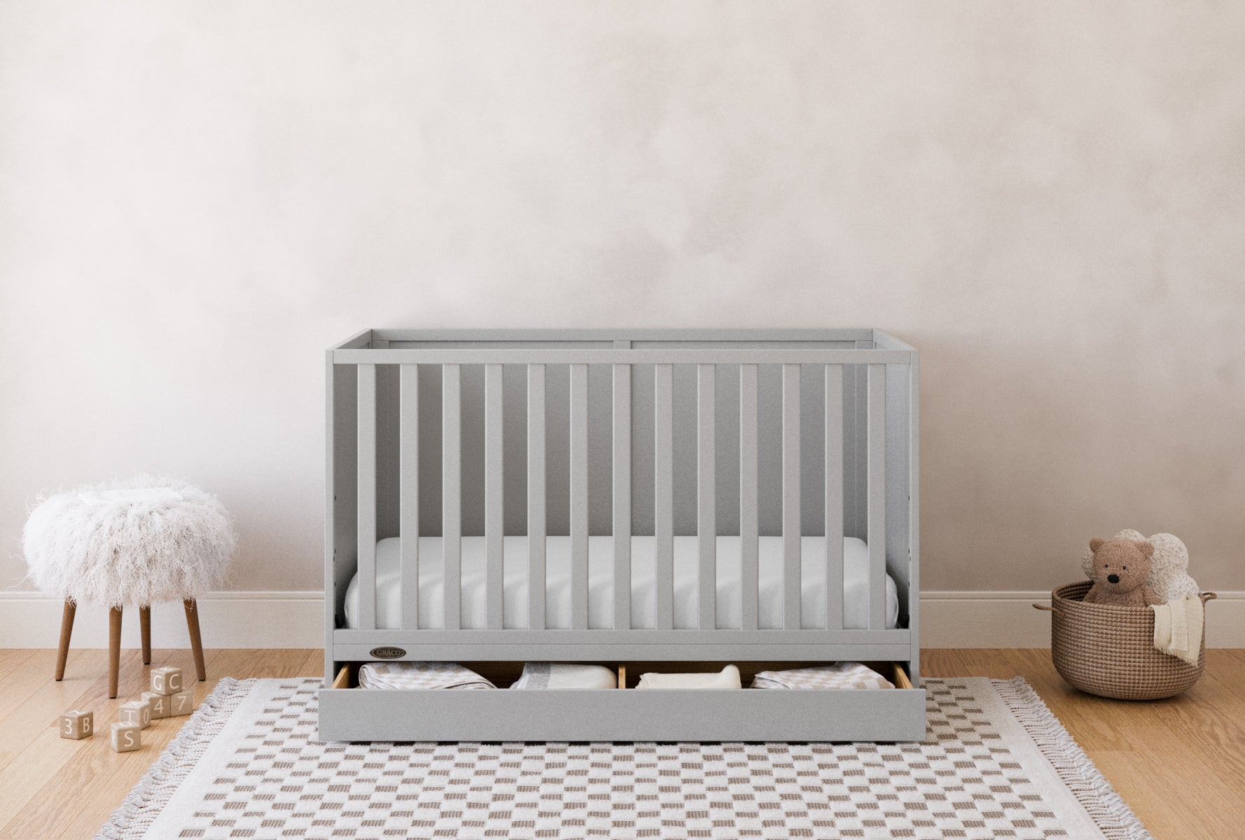 theo crib pebble gray with drawer open nursery shot