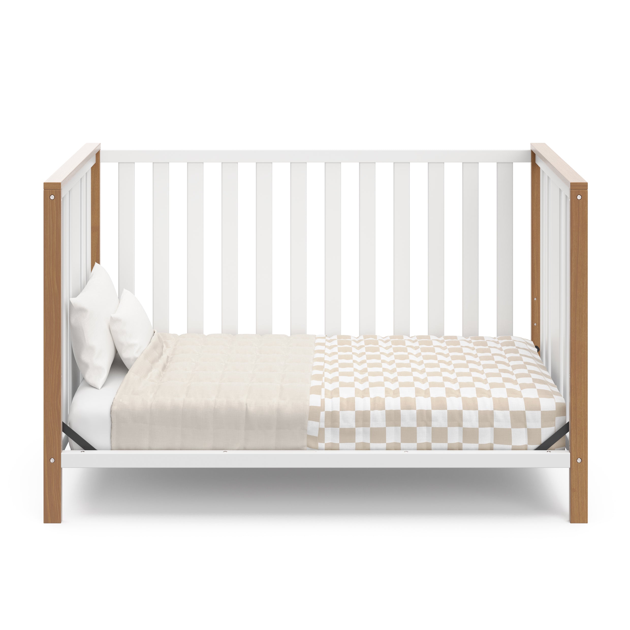 White crib with driftwood in toddler bed conversion