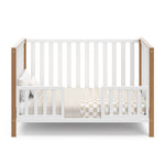 White crib with driftwood in toddler bed conversion with two safety guardrails