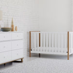 white and vintage driftwood crib and dresser in nursery