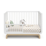 crib in a toddler bed conversion with one guardrail (White with Driftwood)