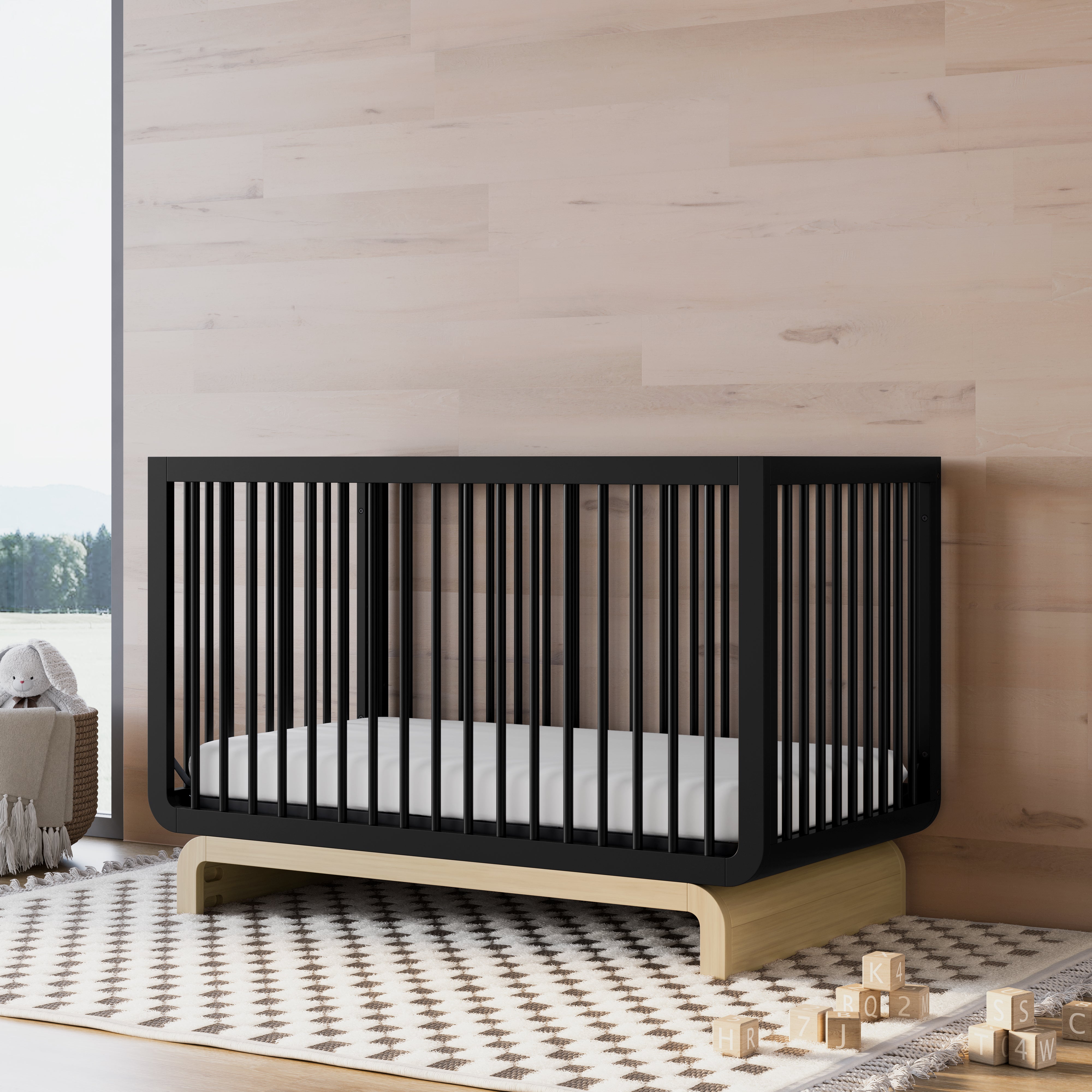 Convertible crib in black with driftwood colorway in a nursery