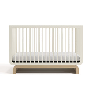 Two-tone frosted oat and natural wood baby crib, at a front-facing angle (Frosted Oat with Driftwood)