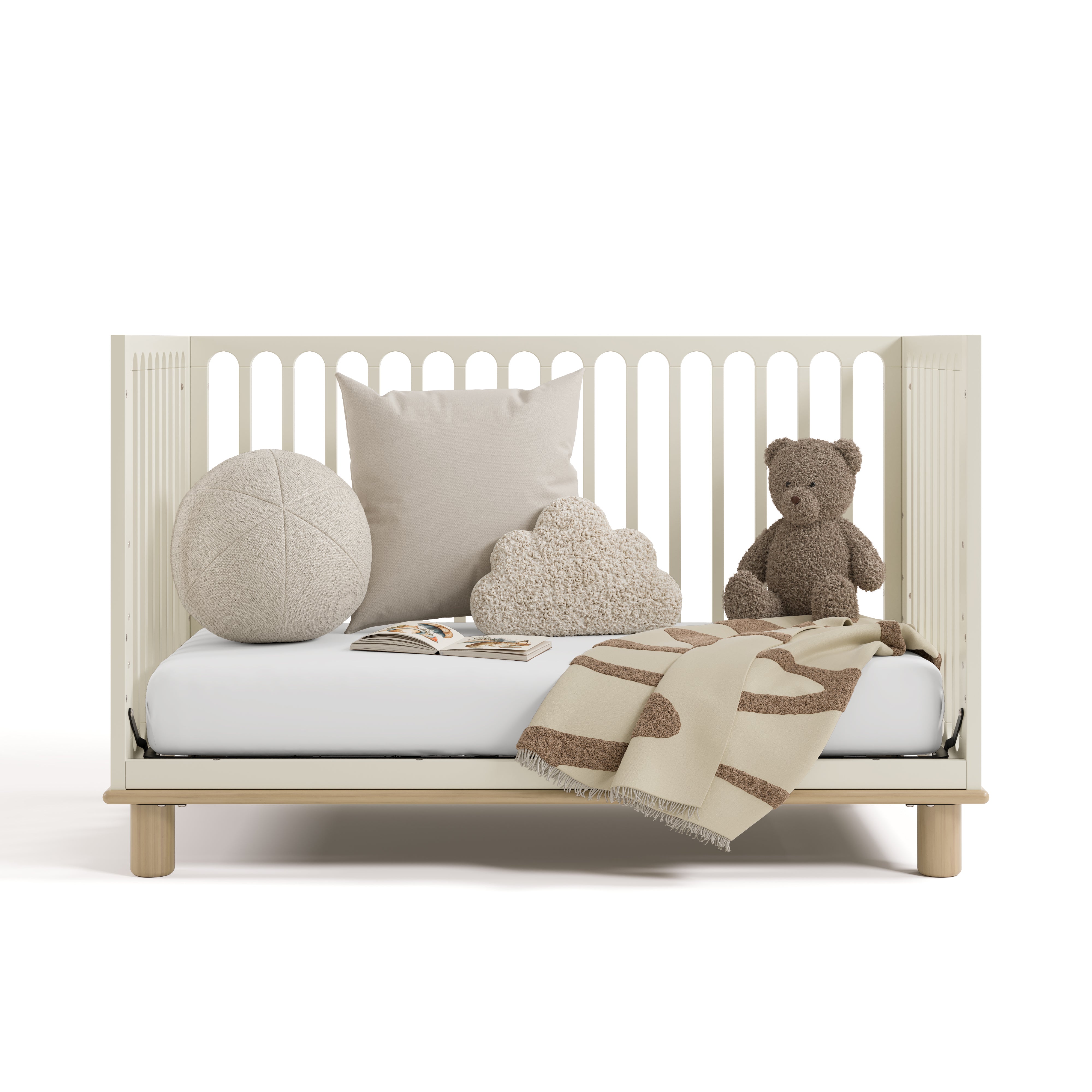 sicily frosted oat with driftwood crib daybed conversion with blanket, pillows, and teddy bear