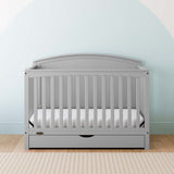 Convertible pebble gray crib in a nursery