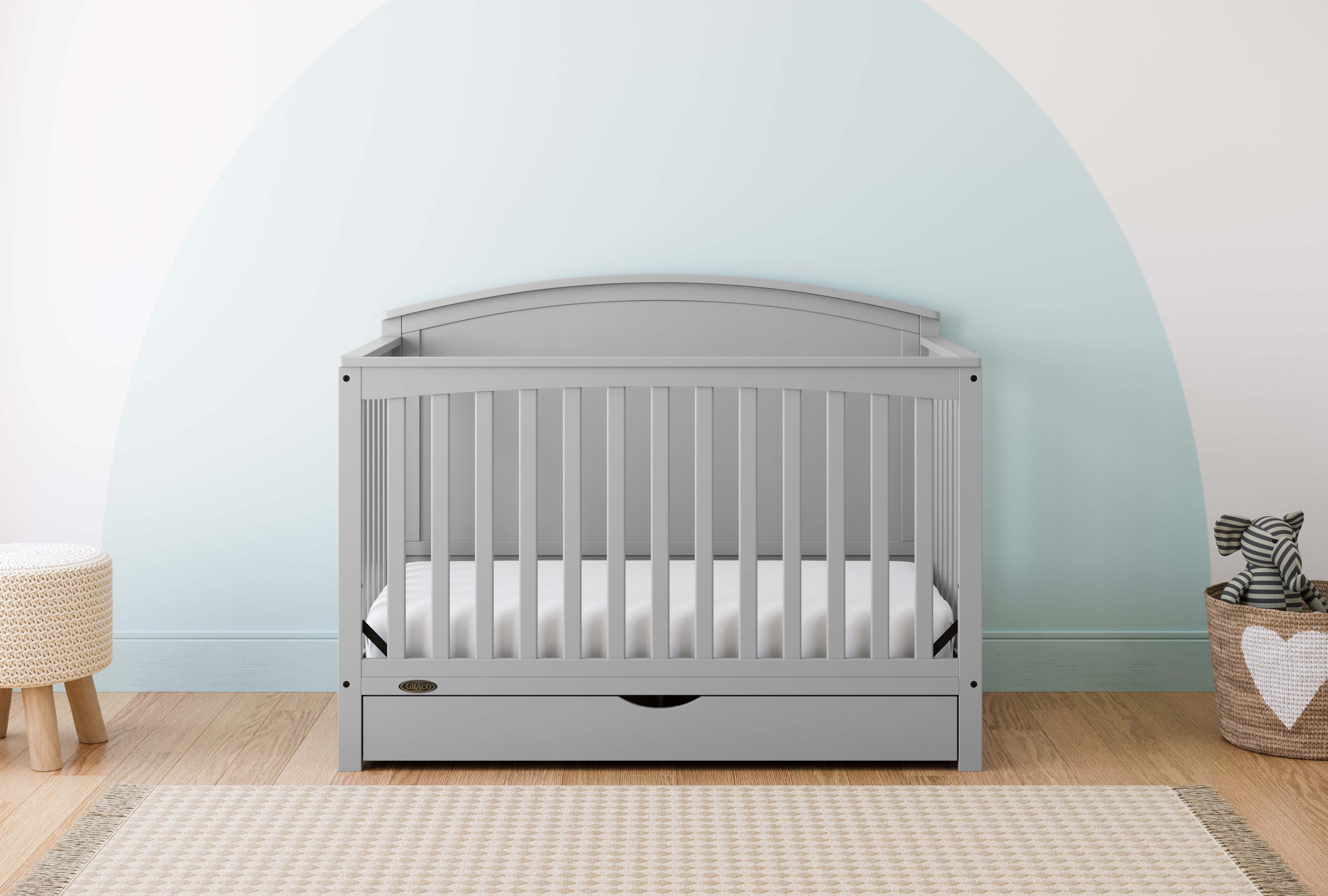 Convertible pebble gray crib in a nursery